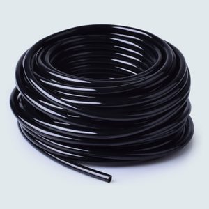 A coiled black plastic tube rests on a light, neutral background.