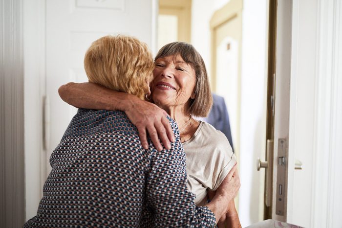 Senior couple visiting friends in their home