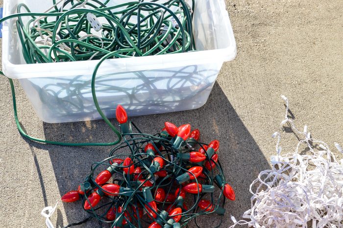 Outdoor Holiday Lights and Extension Cords Laid out on a Driveway