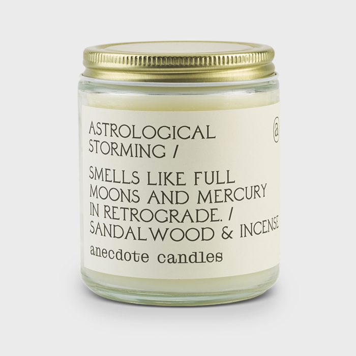 A glass jar candle labeled 