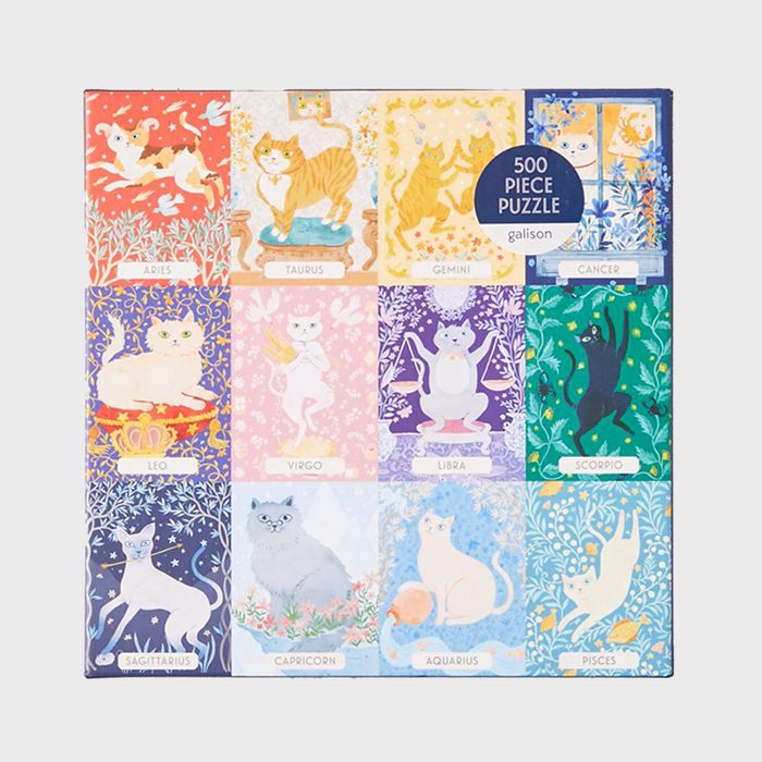 A 500-piece puzzle features colorful illustrated cats representing zodiac signs, each in a decorative, themed background.