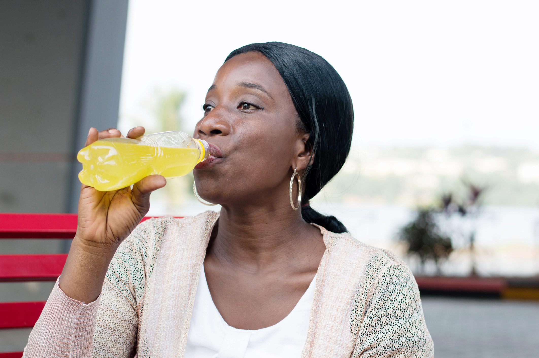Woman drinking a soda at the bottle