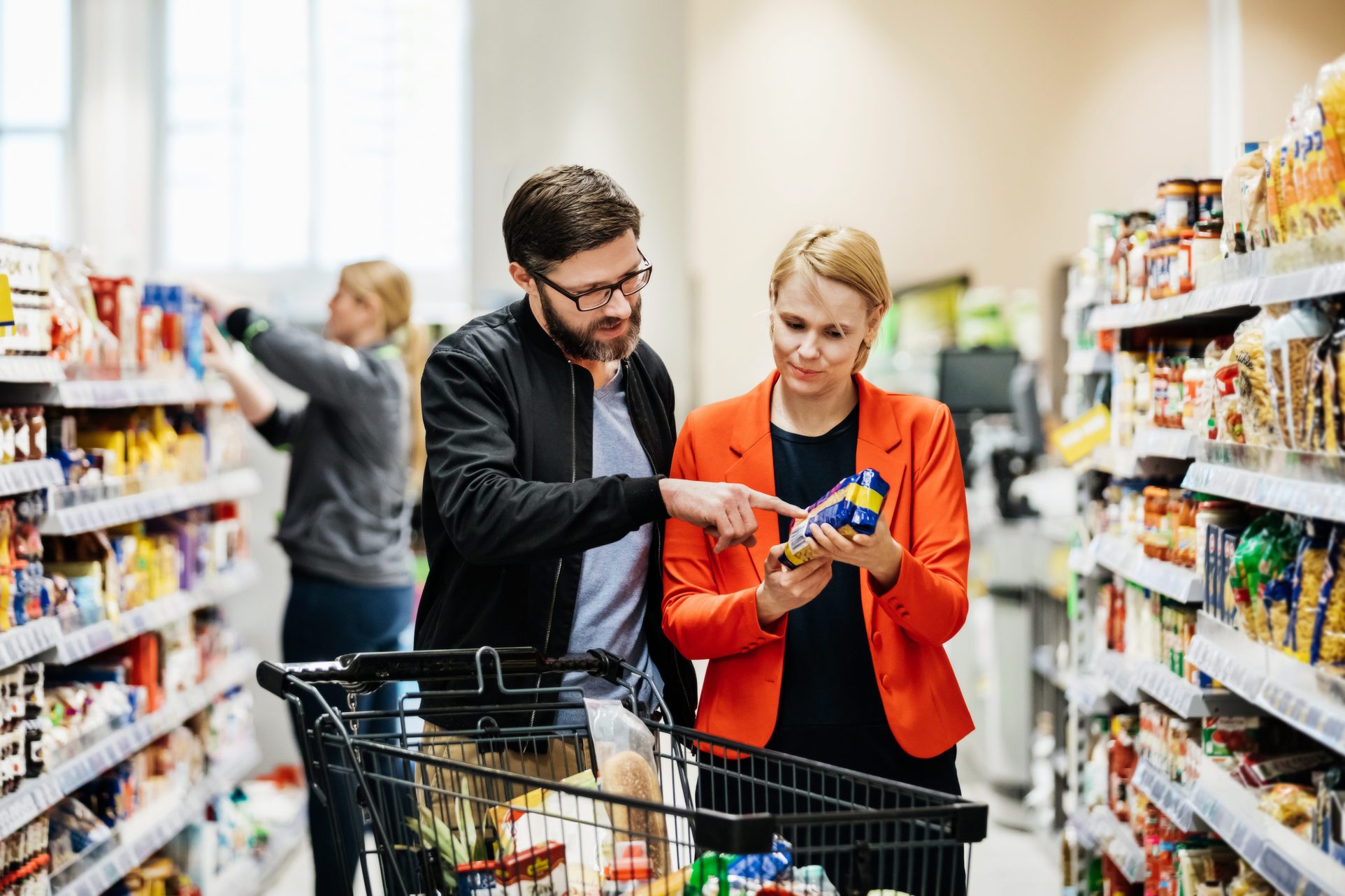 Mature Couple Reading Nutrition Label On Food Item
