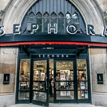 Entrance displays "SEPHORA," doors open to a well-lit cosmetic store. Stone building features decorative elements and large windows.