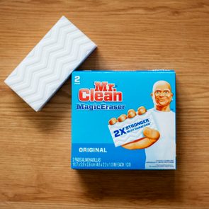 Cleaning pad on wood floor; box labeled 