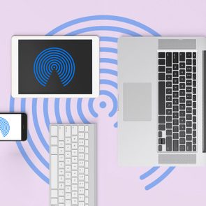 Devices displaying blue concentric circle icons arranged on a light purple surface; includes a smartphone, tablet, laptop, and wireless keyboard.