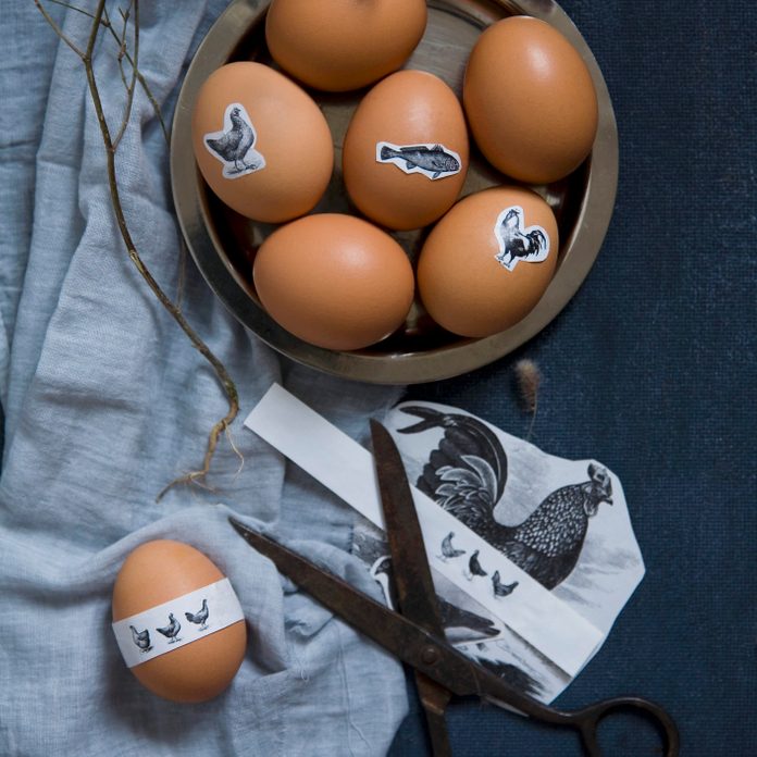 Easter eggs with animal motif stickers in a bowl