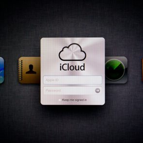 iCloud login screen displays a sign-in form amidst app icons on a digital interface, prompting Apple ID and password entry.