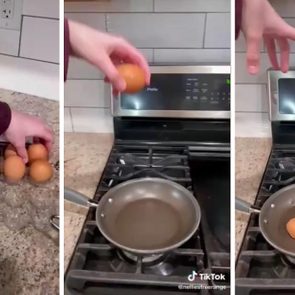 Hand places egg in pan on stove, cracking it open. Kitchen with tiled backsplash and countertop holds egg carton.