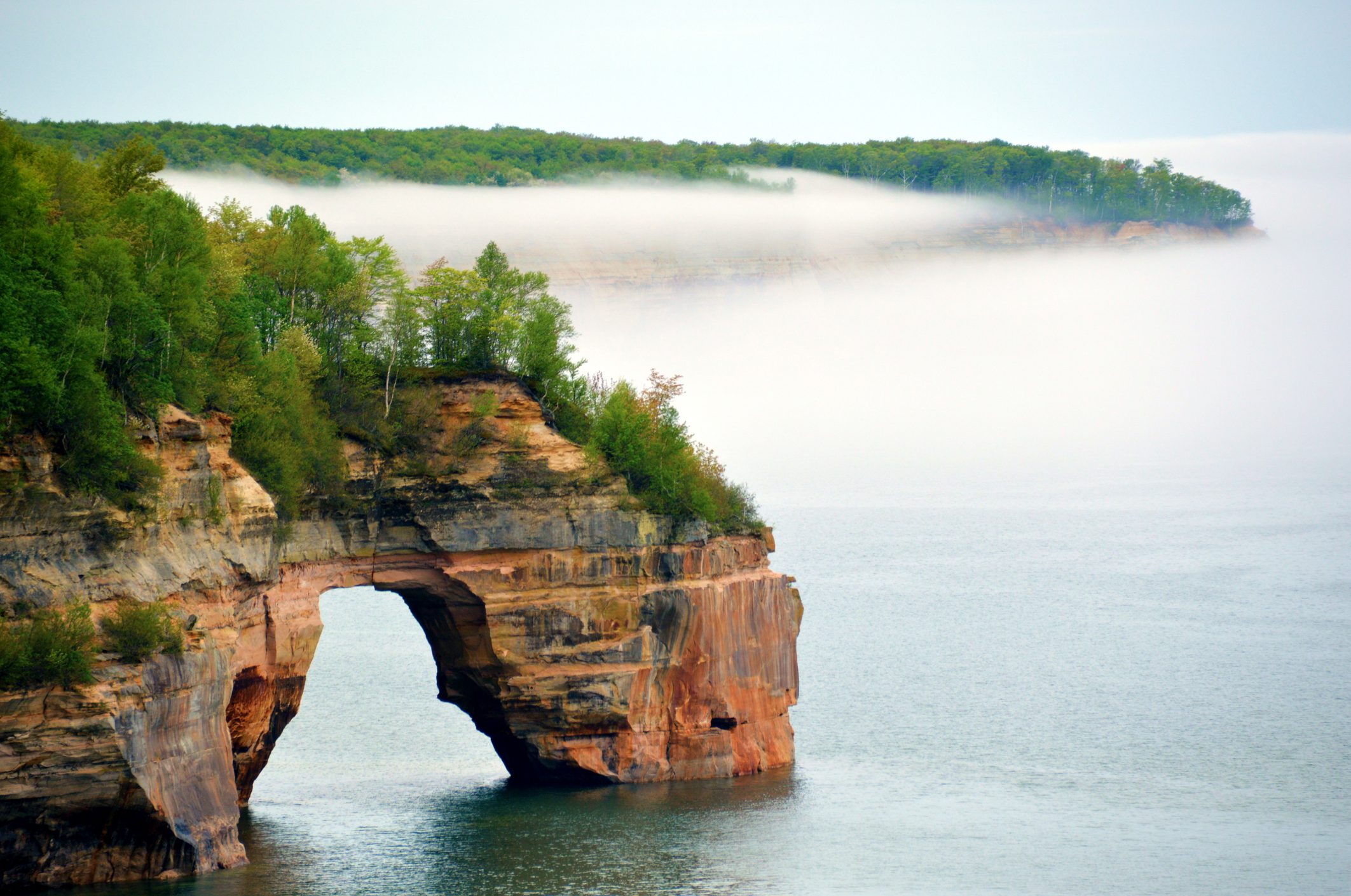 One of the arches along Pictured Rocks National Lakeshore in Michigan's Upper Peninsula with mist in the background