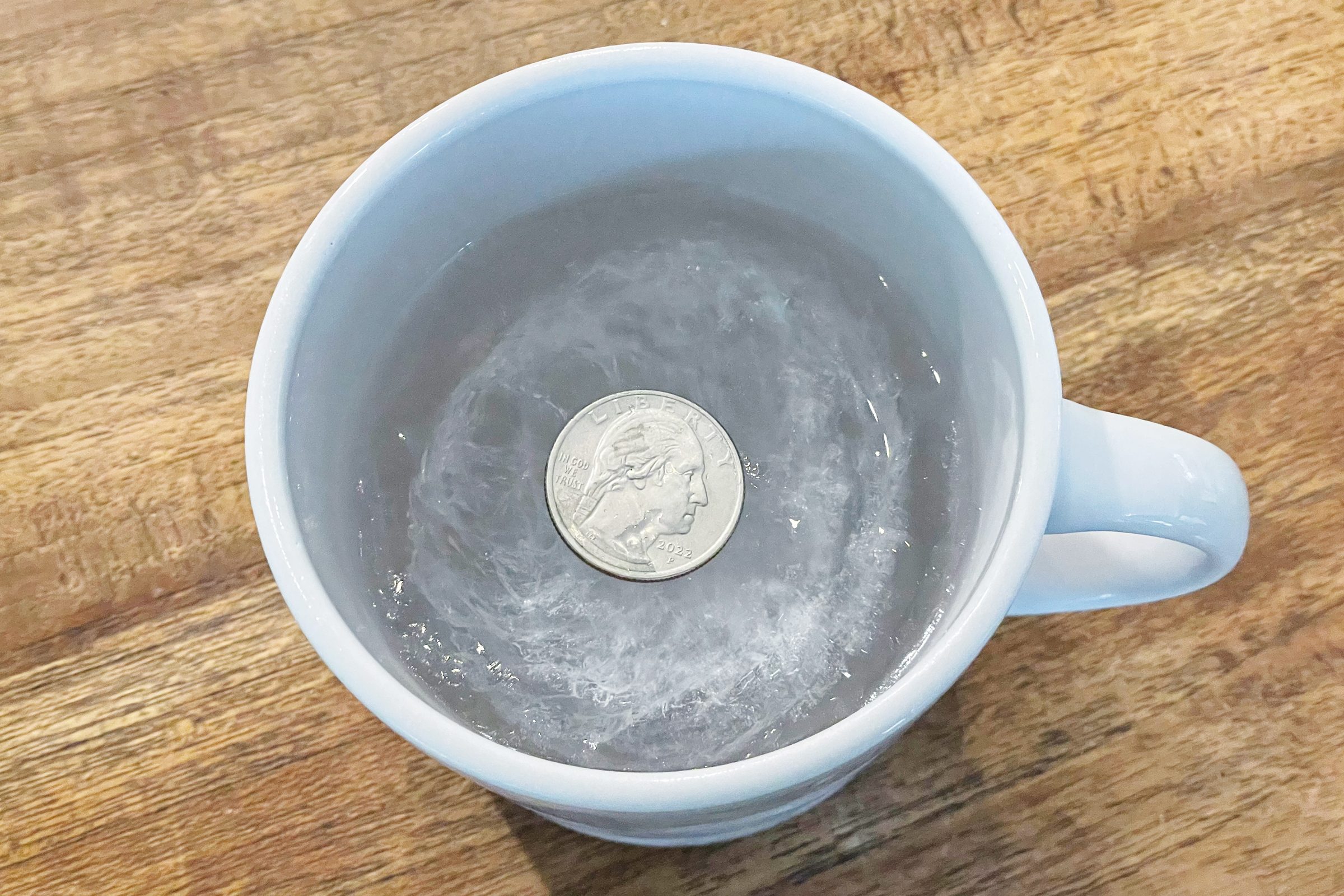 Does Putting a Quarter on a Cup of Frozen Water Before a Major Storm Actually Work?