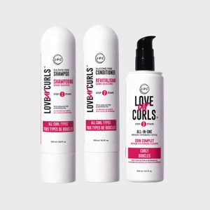 Three hair product bottles stand side by side against a plain background, labeled for curls with shampoo, conditioner, and all-in-one purposes.