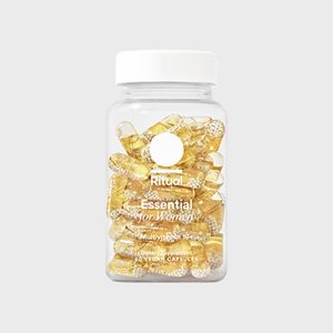 A clear jar filled with yellow capsules labeled 