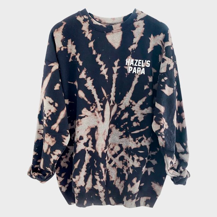 Sweatshirt displays tie-dye pattern, reading 