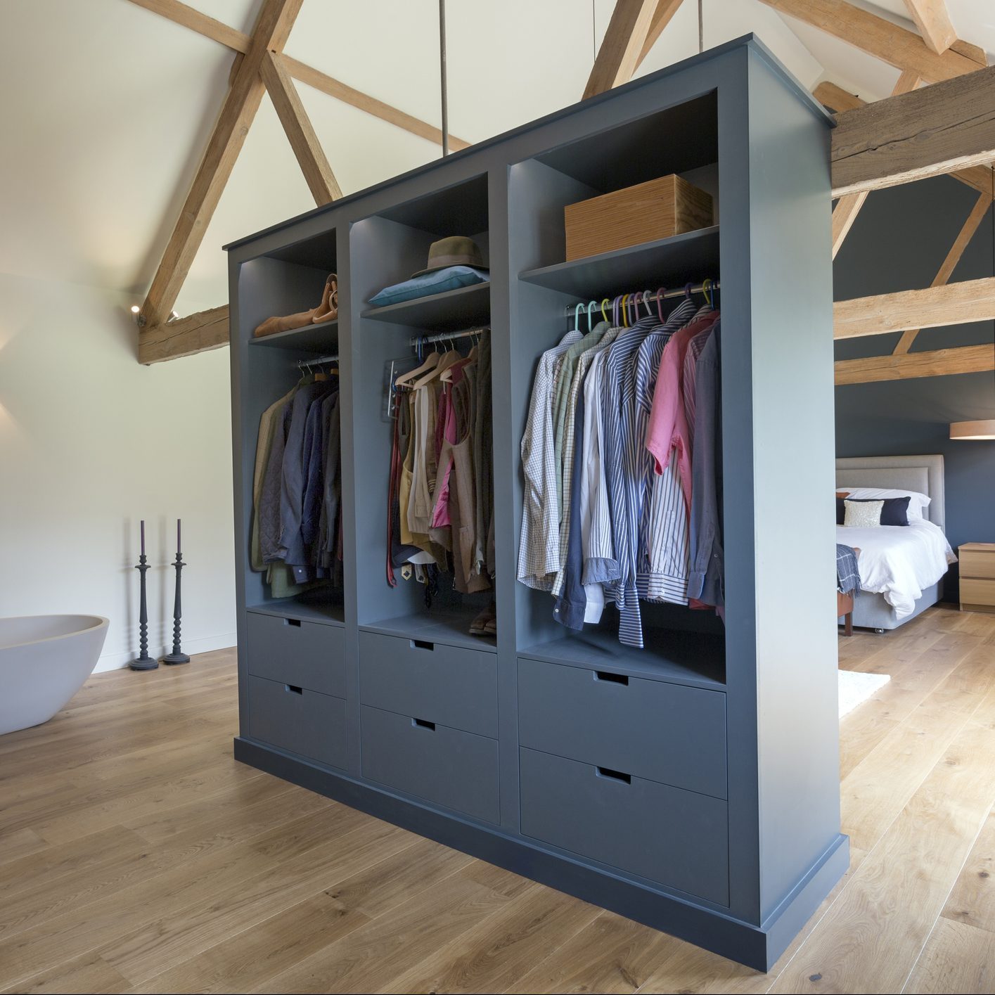 Closet and bathtub in modern bedroom
