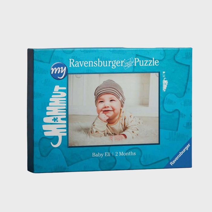 Puzzle box features a smiling baby wearing a striped hat, lying on a soft surface. Text: 