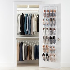 Closet door displays organized shoes; inside, clothes hang neatly in two rows, creating a tidy appearance in a brightly lit room.