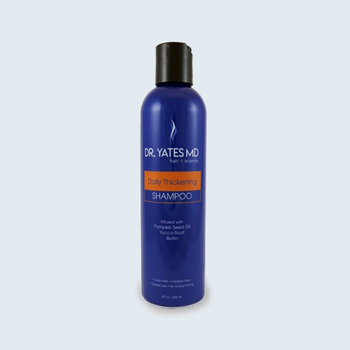 Blue shampoo bottle stands upright, featuring 