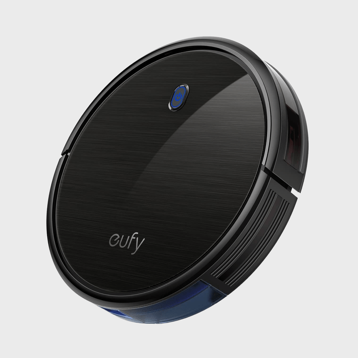 Eufy robotic vacuum rests on a plain, light background, showcasing its sleek black design with a blue power button and 