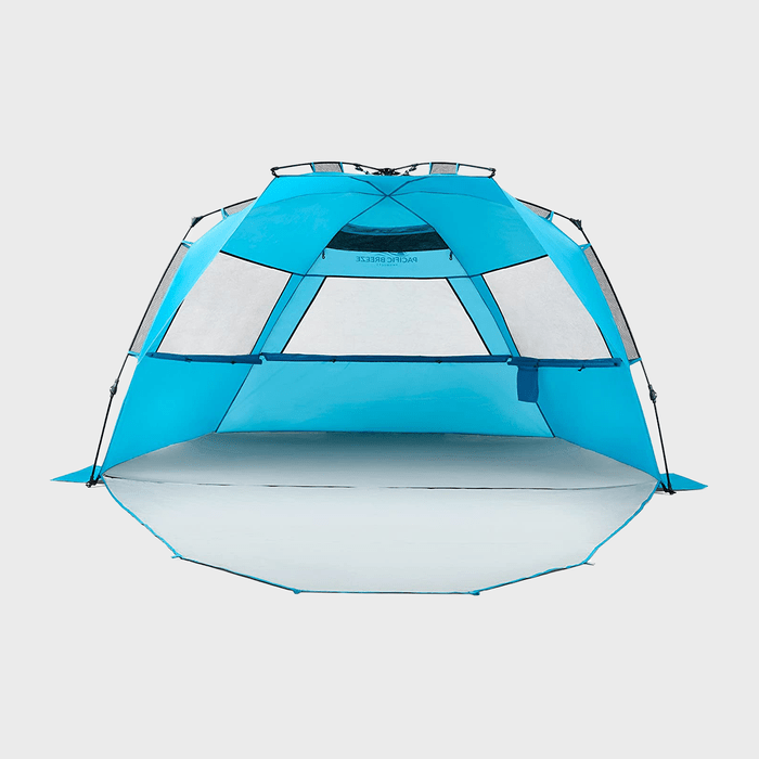 Bright blue beach tent stands open, featuring mesh windows for ventilation, with 