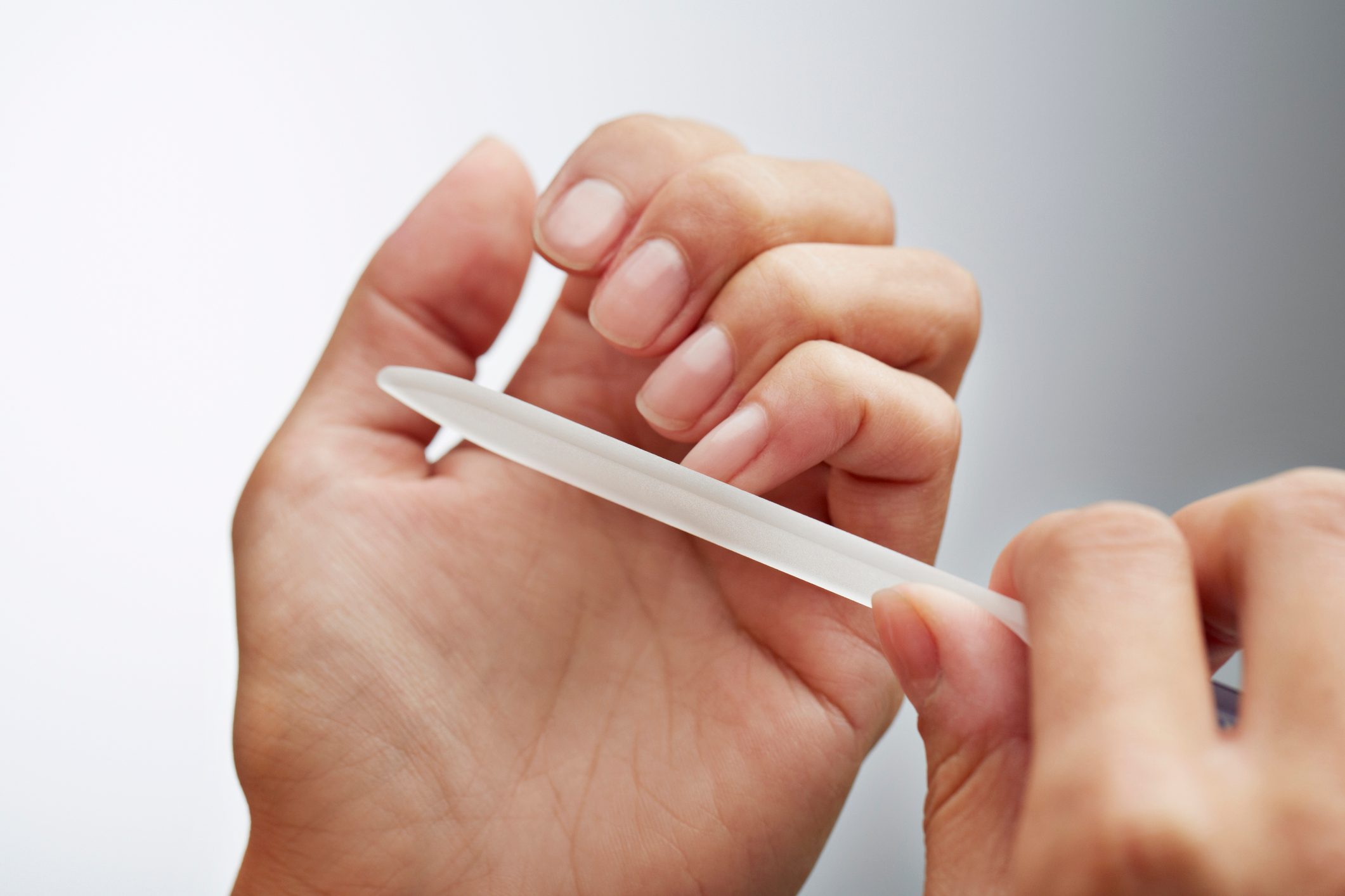Close-up of woman filing her nails