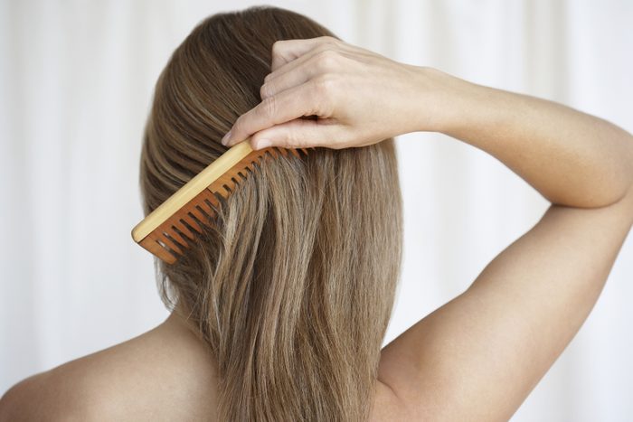 Woman combing hair