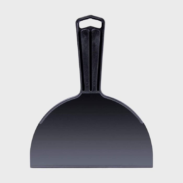 A large black drywall taping knife with a flat blade and a sturdy handle, positioned vertically against a plain gray background.