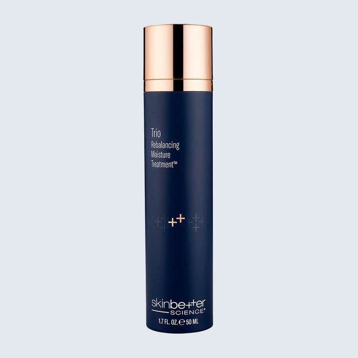 Dark blue cylindrical bottle with a gold cap, labeled 