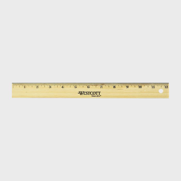 Wooden ruler with inch markings, lying flat, labeled 