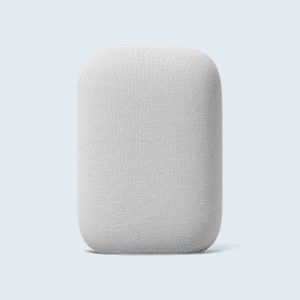 A grey, fabric-covered smart speaker stands upright against a pale blue background.