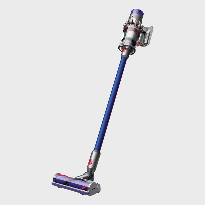 A cordless vacuum cleaner with a long blue handle stands upright against a plain white background.