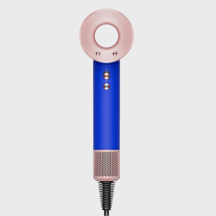 Hair dryer is upright; sleek blue and pink design with circular nozzle and control buttons; positioned against a plain white background.