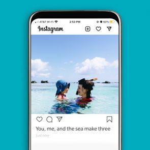 Phone shows a social media post featuring two people swimming in clear ocean water under a blue sky. Text: 