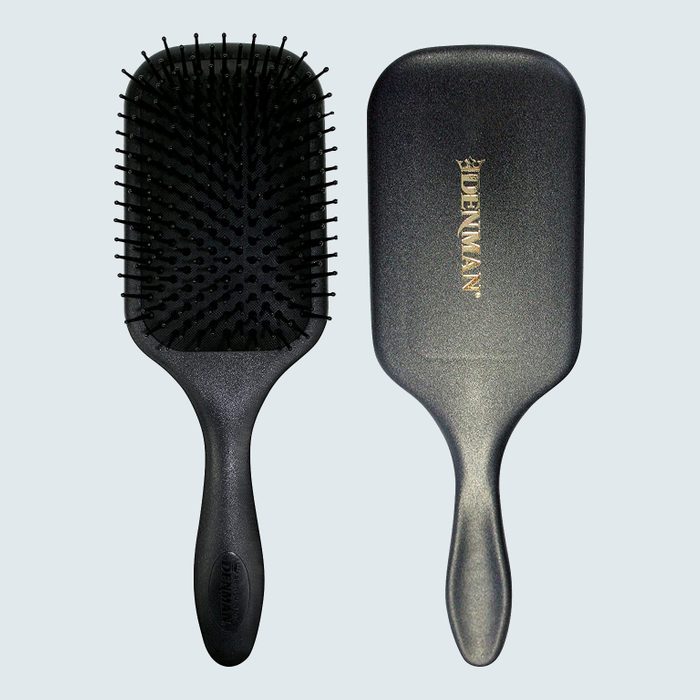 Black paddle hairbrush with bristles facing forward and another showing its back. 