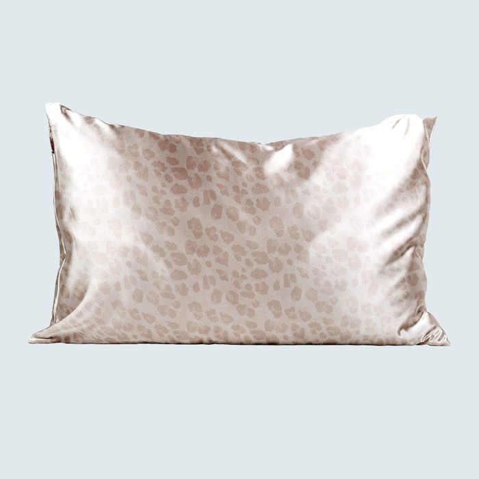 Shiny pillowcase with a subtle leopard print pattern sits against a plain light blue background.