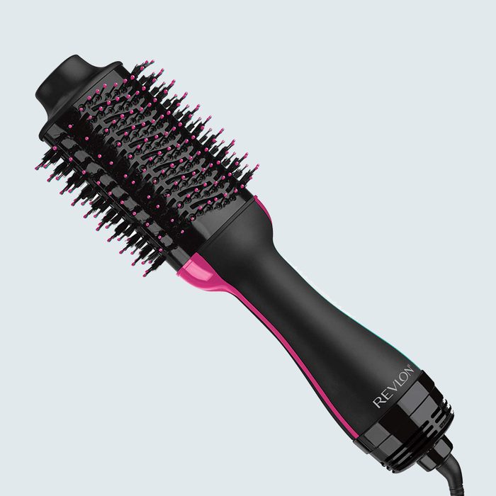 Hair dryer brush with bristles, angled sideways; black and pink handle, labeled 
