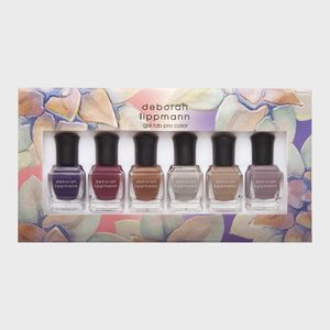 Nail polish bottles displayed in a floral-patterned box, each labeled 