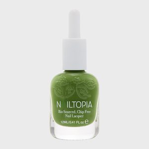 Green nail polish bottle sits on a light surface, labeled 