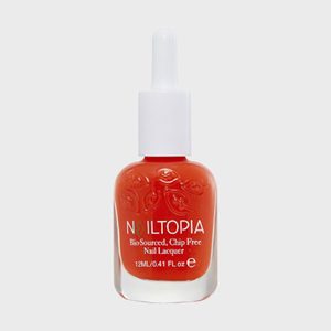 Red nail polish bottle stands upright with white cap, embossed design, and label reading: 