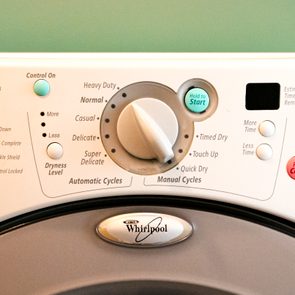 Dryer control panel shows various cycles with a knob for selection and buttons including 