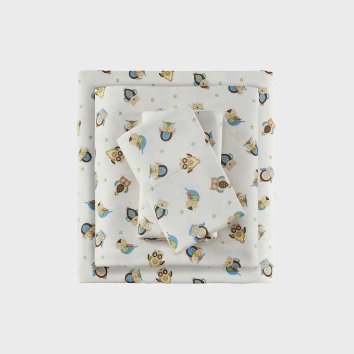 Folded sheets feature owl patterns in brown, green, and blue, set against a light background, arranged in a stacked formation.