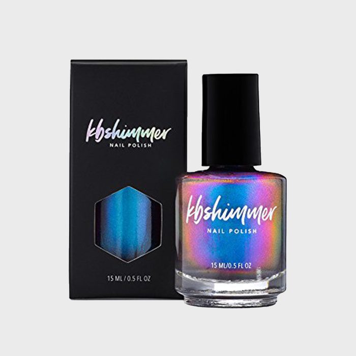 Nail polish bottle displays multicolor shimmer beside matching box, set against a plain gray background. Text reads 