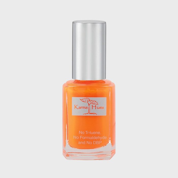 Bright orange nail polish sits in a clear bottle with a silver cap, branded 