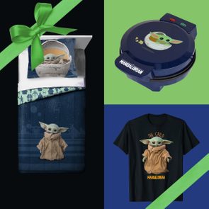 Bedding with character print lies neatly, waffle maker nearby, T-shirt featuring character below; all items have character theme, green ribbon diagonally crosses corners.