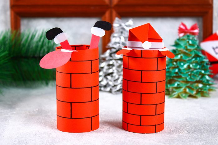 Christmas Santa Claus in chimney made from toilet paper hub, colored paper, marker, glue, fishing line and cotton pad.