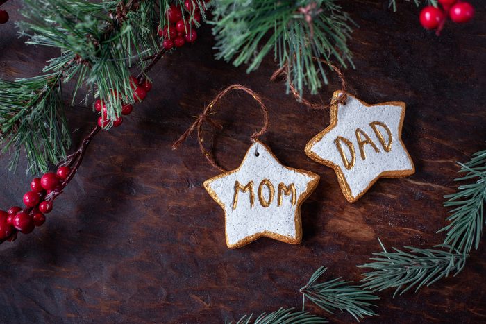 hand painted Christmas star ornaments for mom and dad on festive tree