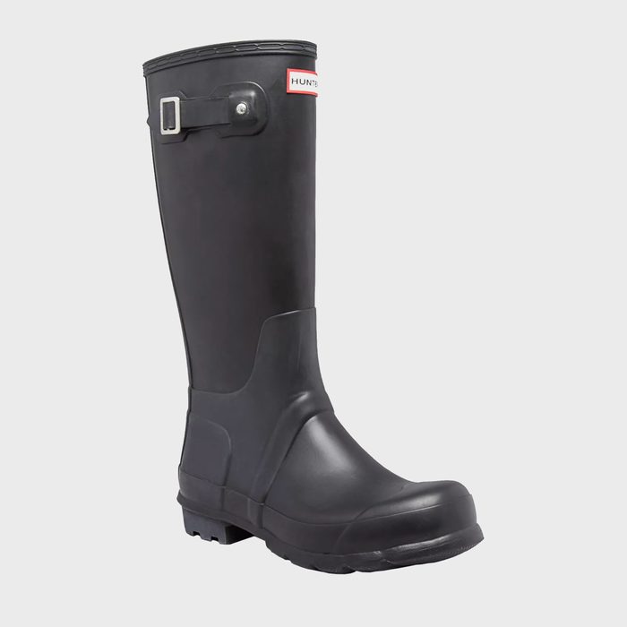 A black rubber boot stands upright with a buckle strap, featuring a red label 