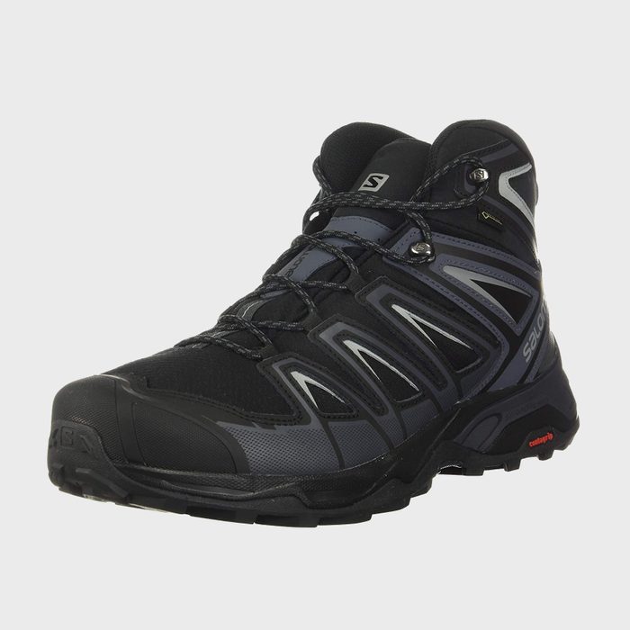 Black hiking boot with intricate lacing stands on plain white background, featuring brand name 