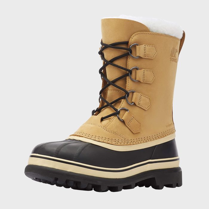 Tan winter boot with black rubber sole and lace-up front details, displayed on a white background. 