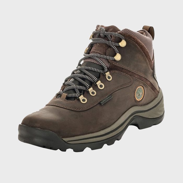 Brown hiking boot with black-and-white laces stands against a plain white background, showcasing its rugged and durable design.